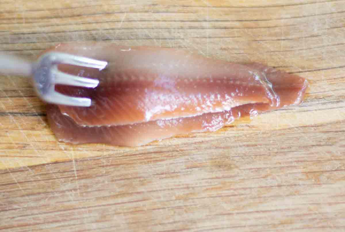 anchovies on a wooden chopping board