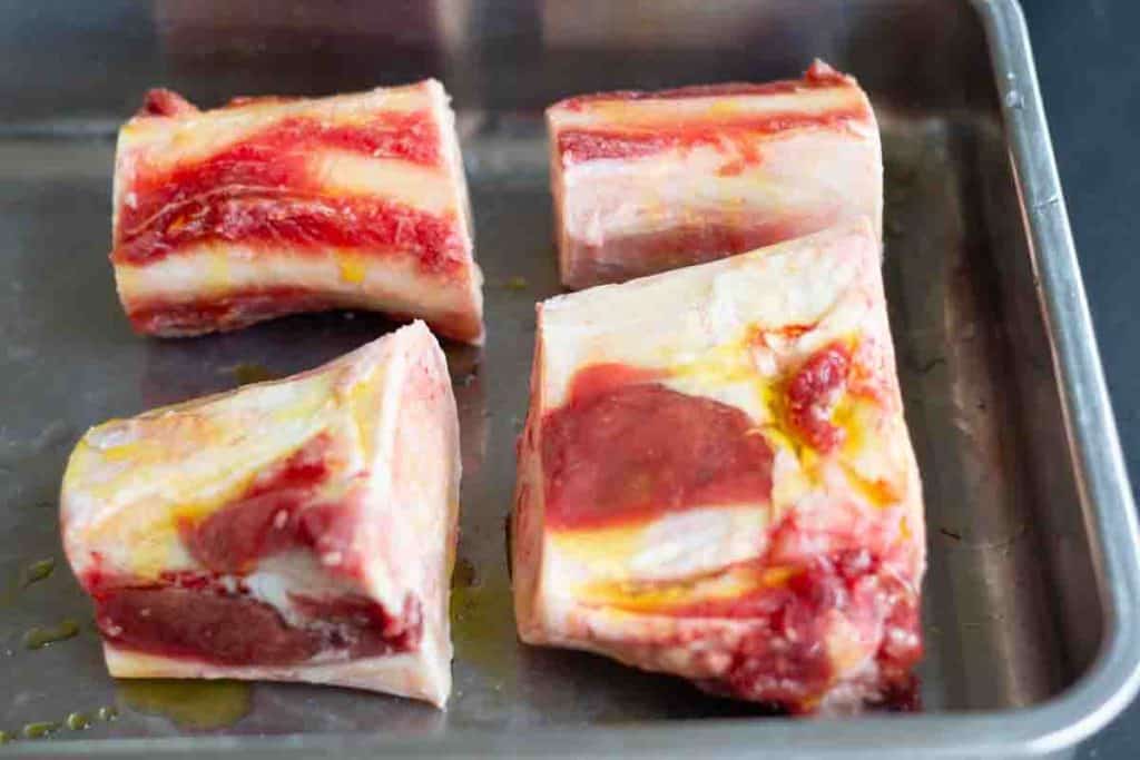 beef marrow bones on a baking sheet