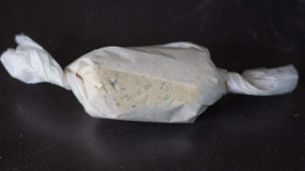 butter of the gods wrapped in a parchment paper and shaped liek a sausage
