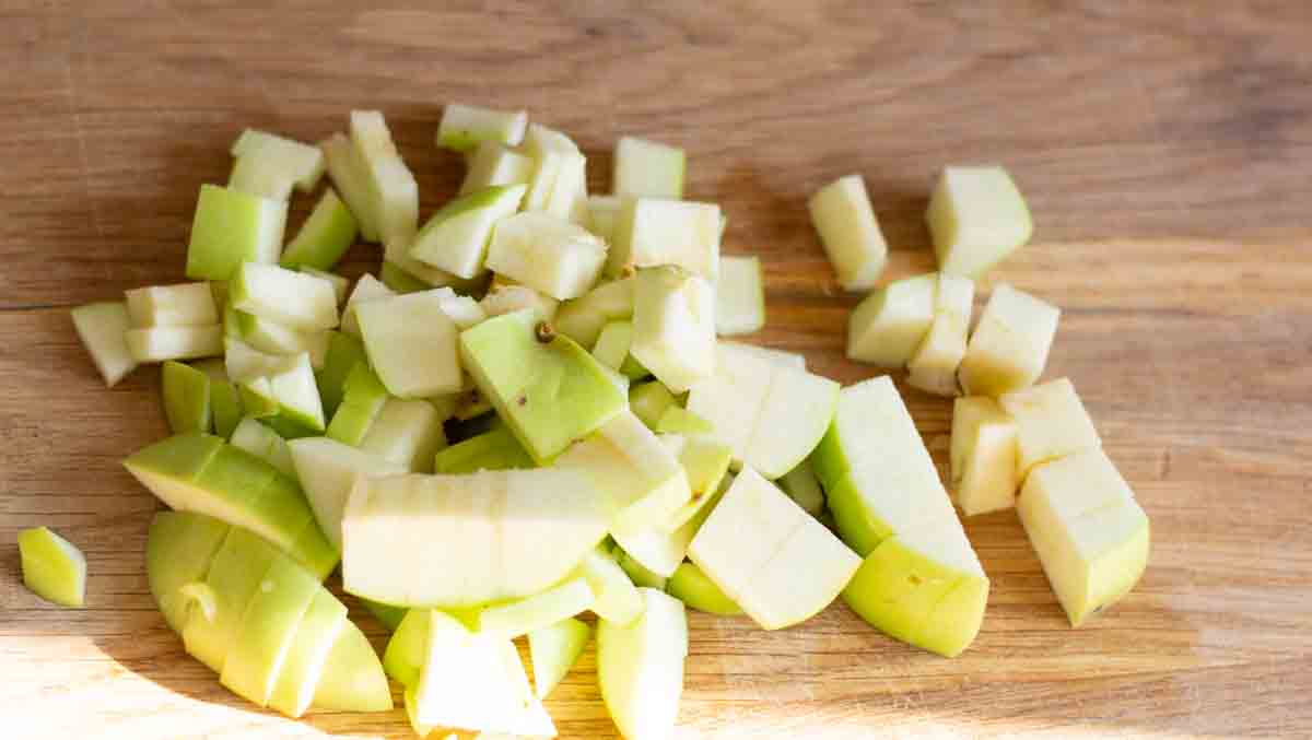 chopped green apple on a wooden chopping board