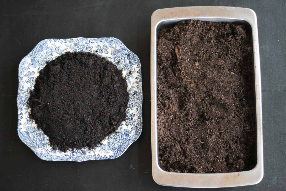 a deep ceramic plate and a baking tin filled with potting soil