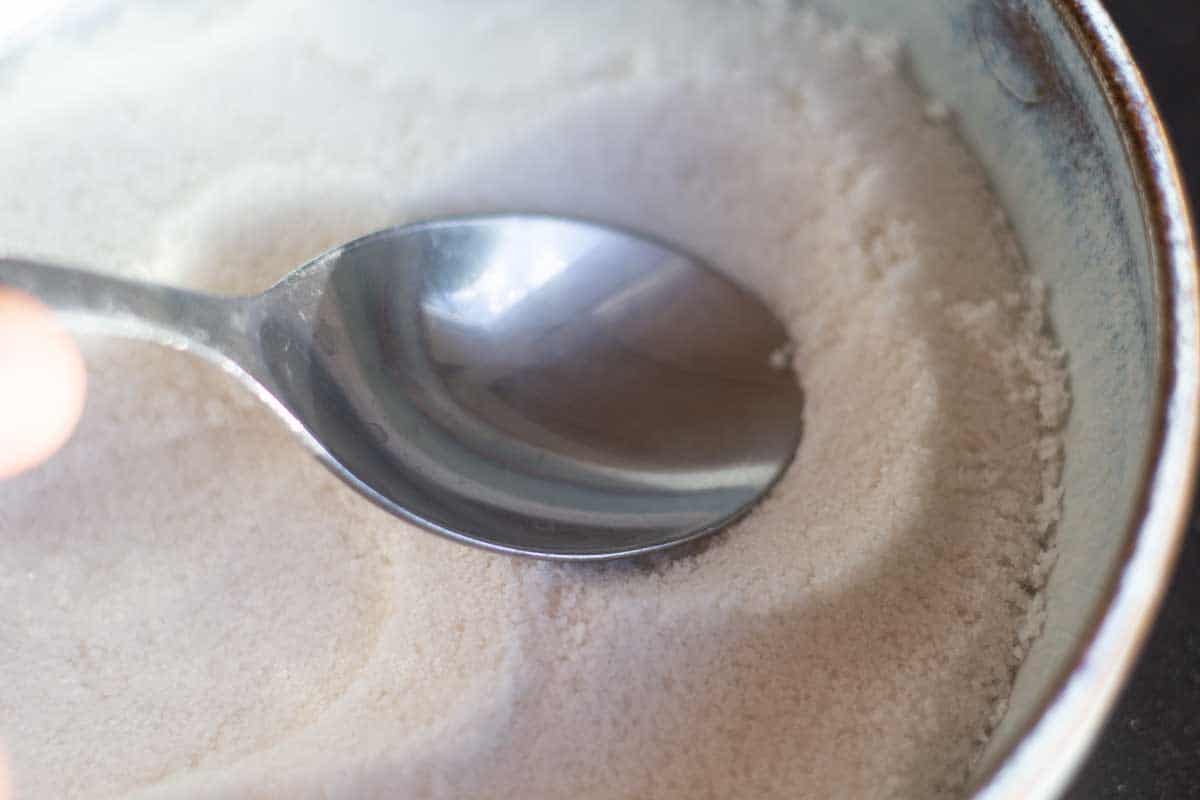a spoon making an indentation in salt