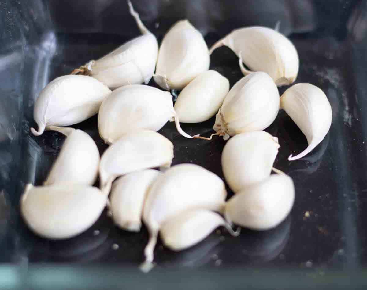 garlic cloves in a roasting dish