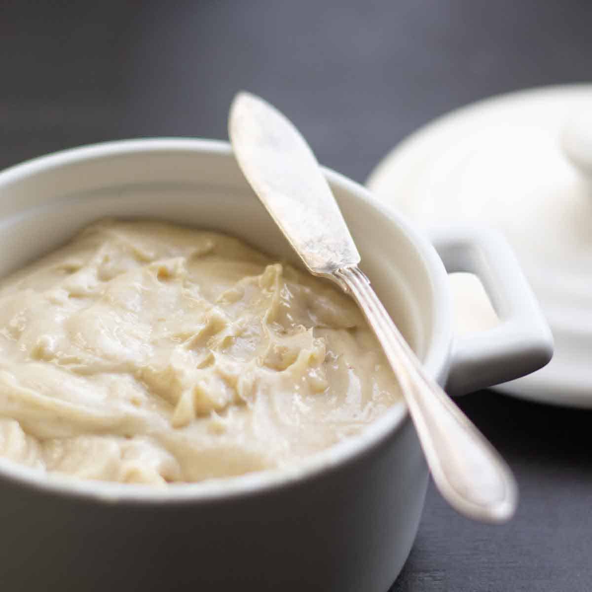horseradish butter in a white ramekin with a silver serving knife
