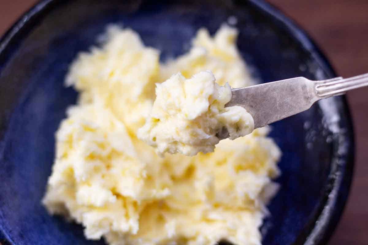 Over head view of emon butter on a silver serving knife