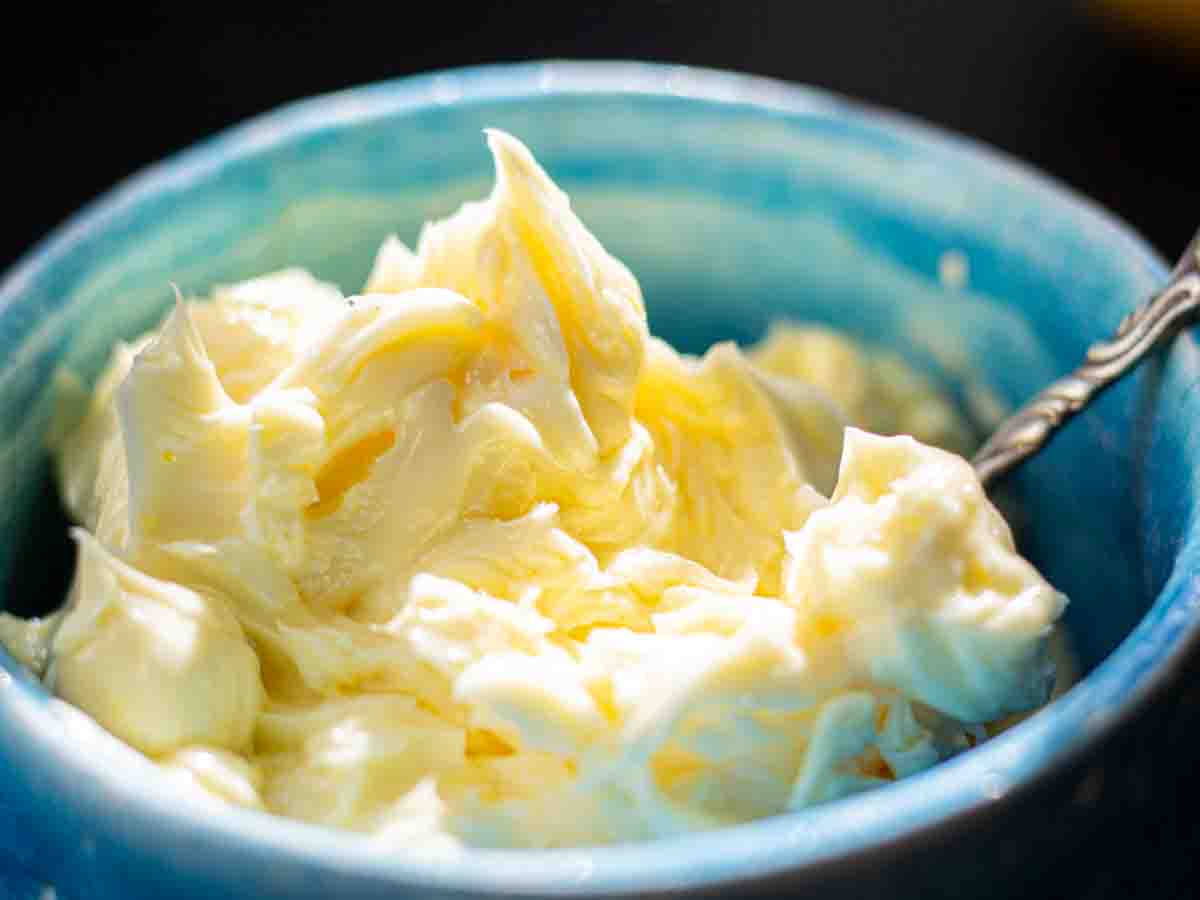 Close up of whipped lemon butter served with an antique silver knife