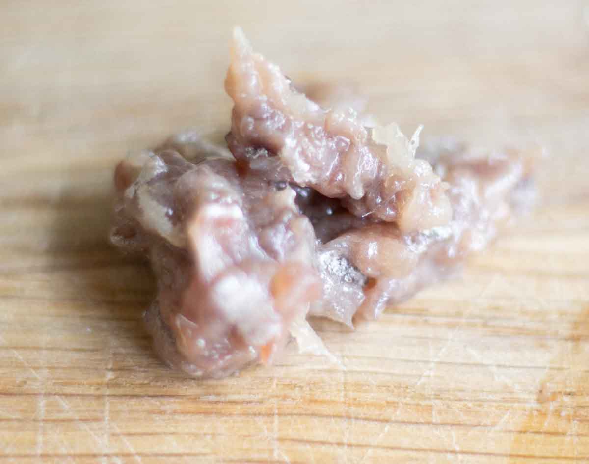 pureed anchovies on a wooden chopping board