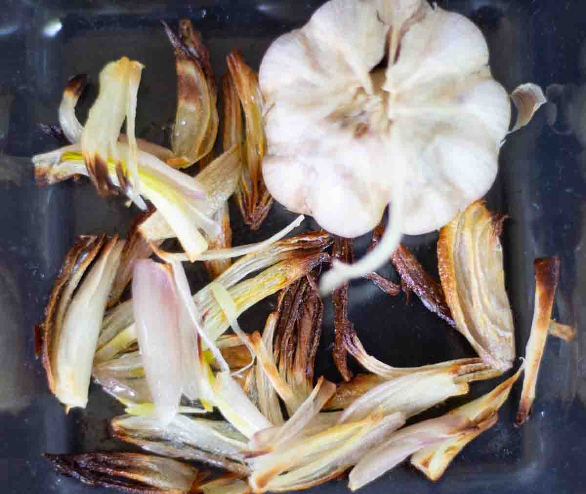 roasted garlic and shallots in a baking dish